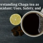 Chaga tea as antioxidant served with lemon and chaga chunks on a wooden table, symbolizing natural detox and immune support.