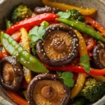 A beautifully plated shiitake mushroom stir fry showcases vibrant vegetables and perfectly cooked mushrooms.