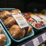 A close-up view of a supermarket shelf highlights a package of porcini mushrooms woolworths among other fresh gourmet ingredients.